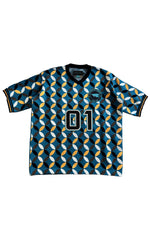 Load image into Gallery viewer, A short-sleeve V-neck jersey with a repeating geometric pattern in teal, black, white, and orange. The front features the number '01' in white with a black outline and a circular crest on the left chest.
